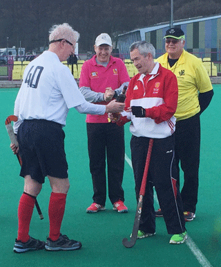 Scotland captain Ally Philip presents Scotland LX whisky  to England captain Brian Perryman